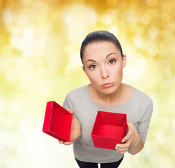 Image showing disappointed asian woman with empty red gift box