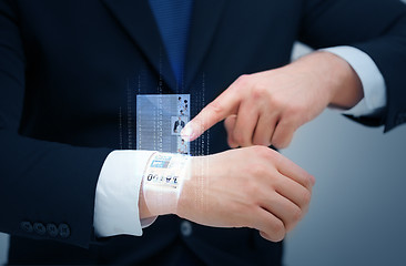 Image showing businessman pointing to something at his hand