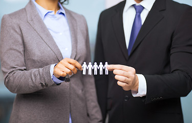 Image showing businessman and businesswoman holding paper team