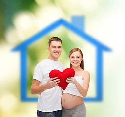 Image showing happy young family expecting child with big heart