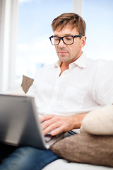 Image showing man working with laptop at home