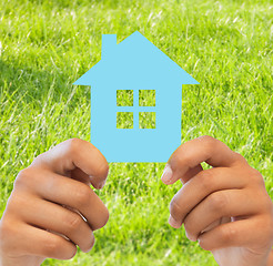 Image showing woman hands holding blue house