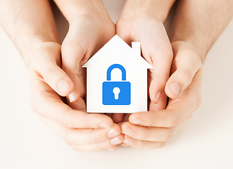 Image showing hands holding paper house with lock