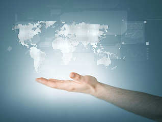 Image showing mans hand showing world map