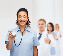 Image showing smiling female african american doctor or nurse