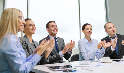 Image showing business team with laptop clapping hands