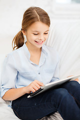 Image showing smiling girl with tablet computer at home