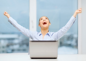 Image showing screaming businesswoman with laptop in office