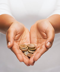 Image showing womans cupped hands showing euro coins