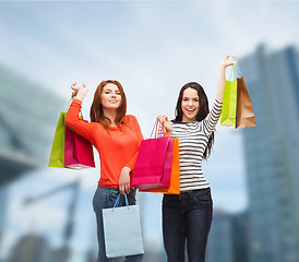 Image showing two smiling teenage girls with shopping bags