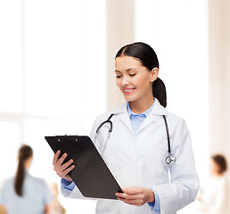 Image showing smiling female doctor with clipboard