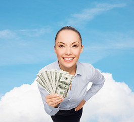 Image showing smiling businesswoman with dollar cash money