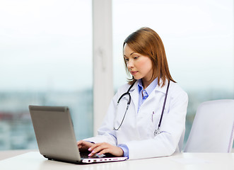 Image showing busy doctor with laptop computer