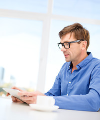 Image showing man working with tablet pc at home