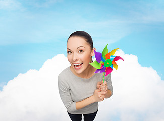 Image showing smiling asian woman with windmill