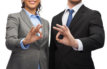 Image showing businessman and businesswoman showing ok sign