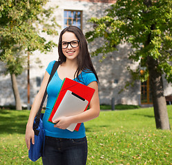 Image showing smiling student with bag, folders and tablet pc