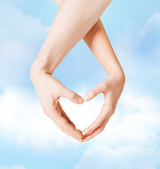 Image showing woman and man hands showing heart shape