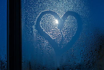 Image showing Moonlight through the window. Sweaty glass and heart