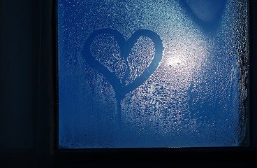 Image showing Moonlight through the window. Sweaty glass and heart