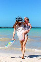 Image showing Mom daughter having a walk at the beach 