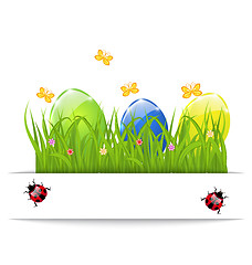Image showing Easter colorful eggs in green grass with space for your text
