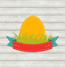 Image showing Vintage label with Easter egg on wooden background 