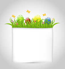 Image showing Easter colorful eggs in green grass with empty paper for your te