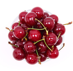 Image showing Ripe fresh cherry in the glass isolated on white background