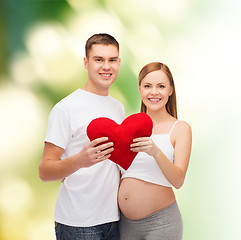 Image showing happy young family expecting child with big heart