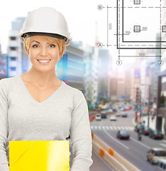 Image showing female contractor in helmet with folder