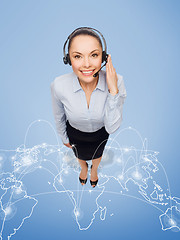 Image showing friendly female helpline operator with headphones