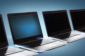 Image showing many laptop computers with blank black screens