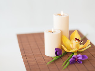 Image showing candles, orchid and iris flowers on bamboo mat