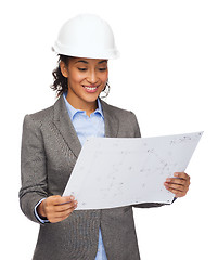 Image showing businesswoman in white helmet with blueprint