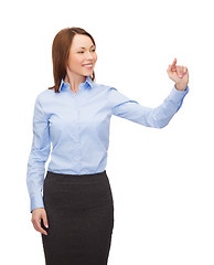 Image showing smiling businesswoman working with virtual screen