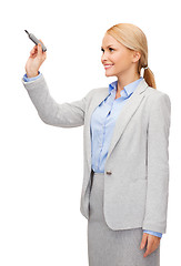 Image showing businesswoman writing something in air with marker