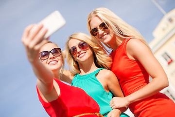 Image showing smiling girls taking photo with smartphone camera