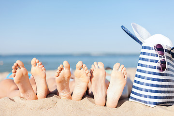 Image showing three women lying on the beach