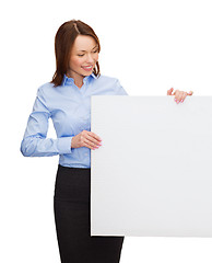 Image showing smiling businesswoman with white blank board