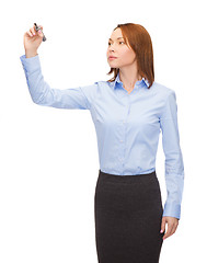 Image showing businesswoman writing something in air with marker