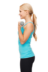 Image showing young sporty woman with light dumbbells