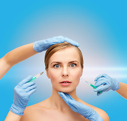 Image showing woman face and beautician hands with syringe