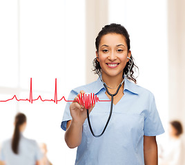 Image showing smiling female african american doctor or nurse