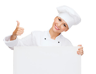 Image showing smiling female chef with white blank board