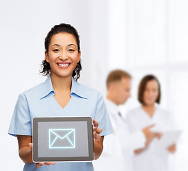 Image showing smiling female doctor or nurse with tablet pc