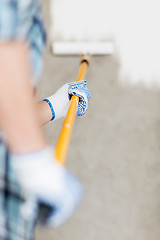 Image showing man colouring the wall with roller