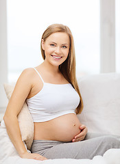 Image showing happy pregnant woman touching her belly