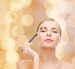 Image showing beautiful woman with makeup brush