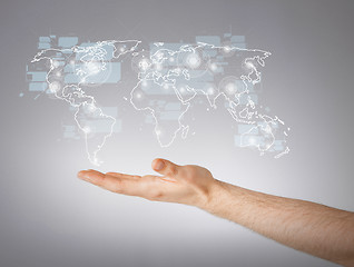 Image showing mans hand showing world map